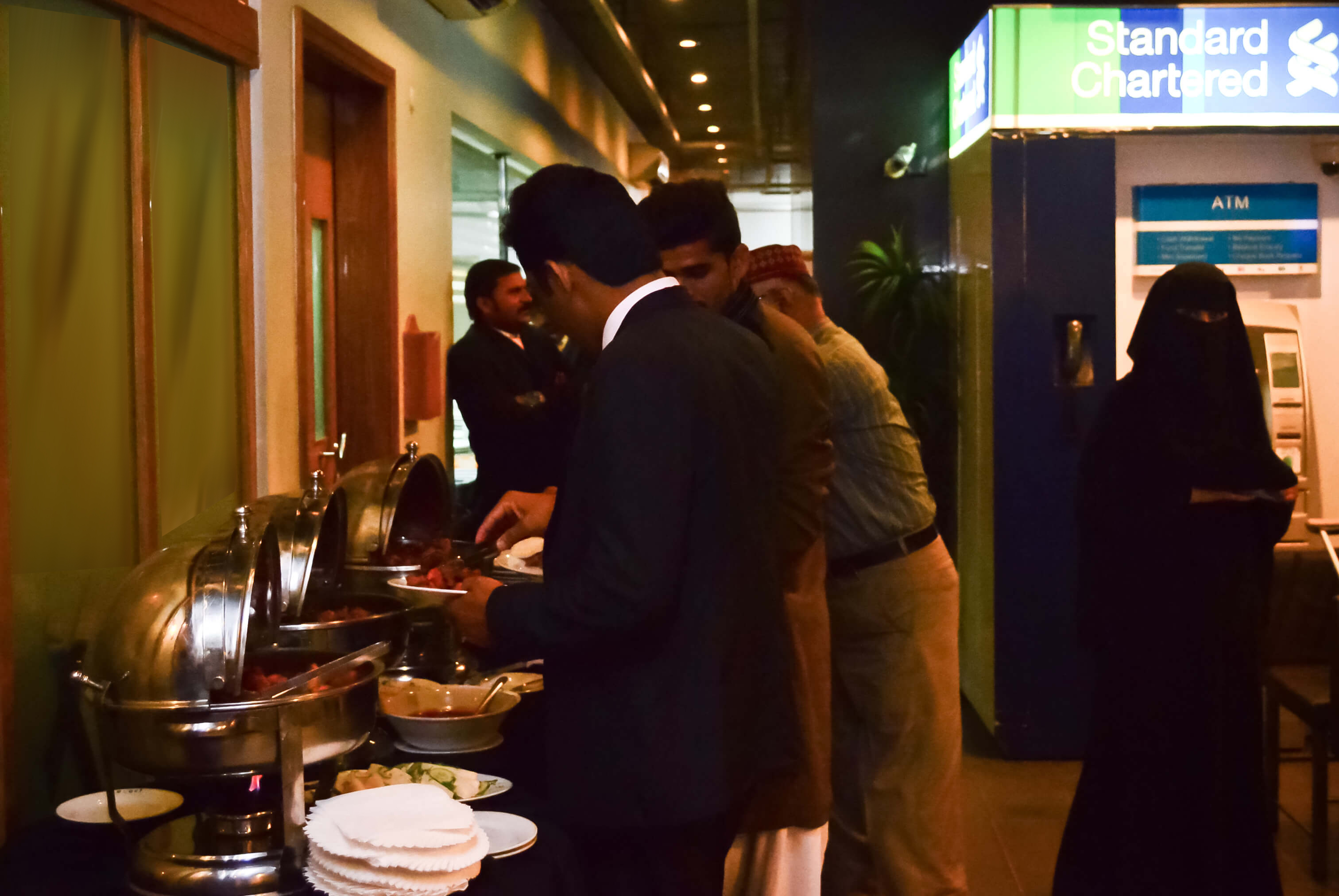 The family members helping themselves to hi-tea served for all guests.