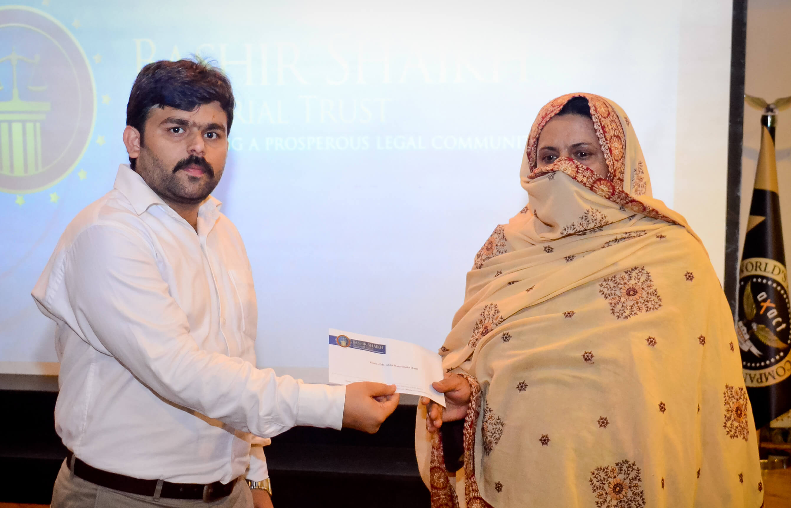 Mr. Imdad Ali Saheto, Secretary, BSMT, presenting a cheque to the family member of the deceased member.