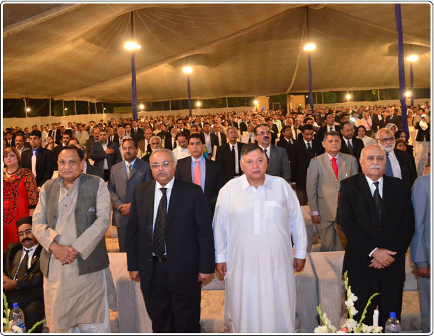 The audience paying their respects to the national anthem.